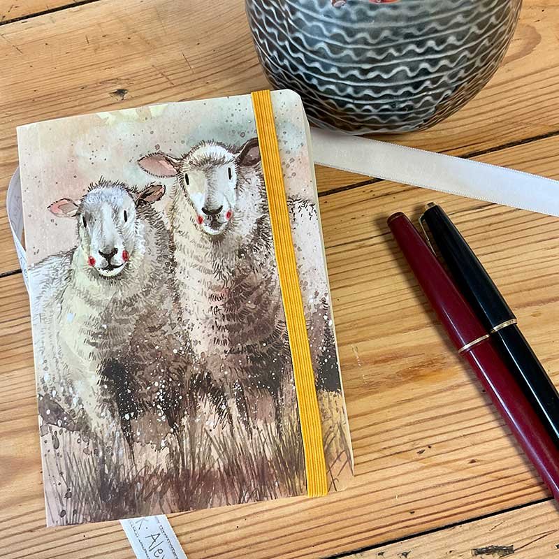 Alex Clark Companions Sheep Small Chunky Notebook on a wooden table with pens