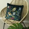 Midnight Garden Bird Cushion Green on a wicker chair