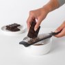 Brabantia Black Sliter Grater being used to grate chocolate