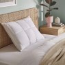 The Fine Bedding Company Natural Latex Foam Pillow lifestyle image of the pillow on a bed