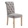 Button Back Scroll Top Dining Chair In Grey angled image of the chair on a white background