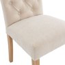 Button Back Scroll Top Dining Chair In Natural close up image of the chair on a white background