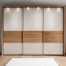 Wiemann Manhattan 3 Door Sliding Wardribe in Champagne Glass with Wooden Trim and Frame with Lights Wiemann Manhattan 3 Door Sliding Wardribe in Champagne Glass with Wooden Trim and Frame with Lights