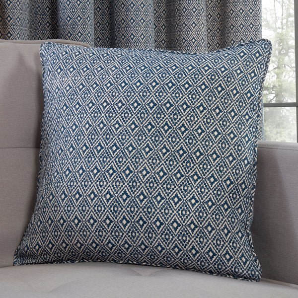 Sundour Aztec Navy Filled Cushion close up of it placed on a sofa