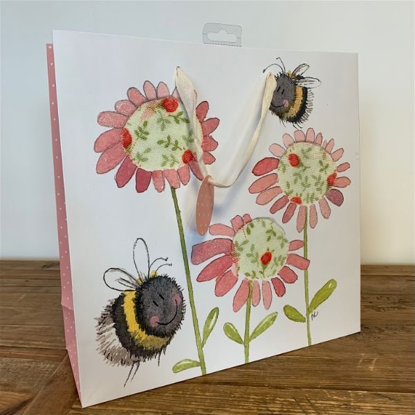 Alex Clark Bee Large Gift Bag on a wooden Table