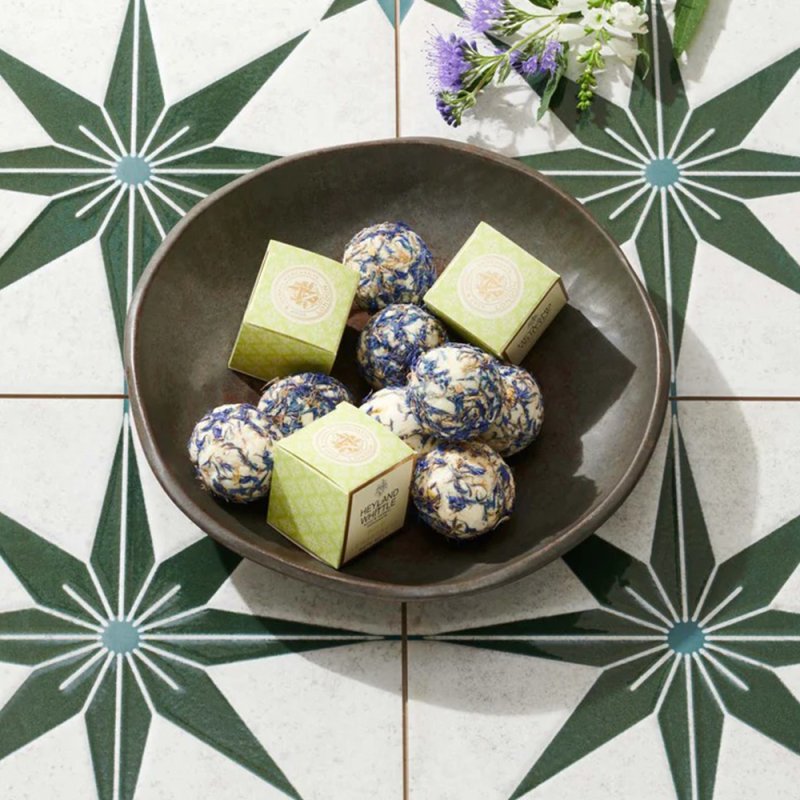 Wild Lemongrass Bath Melt Truffle 40g in bowl on tiled floor