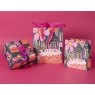 Glick Medium Birthday Candles Gift Bag on a pink background with different size gift bags