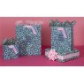 Glick Medium Meadow Gift Bag on a pink background with different size gift bags