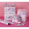 Glick Medium Butterflies Gift Bag on a pink background next to different size gift bags
