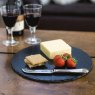 Simply Home Round Slate Cheese Board on a table with cheese, fruit and red wine