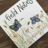 Alex Clark Field Notes Butterflies Mini Magnetic Notepad front close up on a wooden table