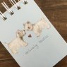 Alex Clark Welcoming Westies Dogs Small Spiral Notepad close up of the front cover on a wooden table