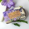 The English Soap Company Anniversary Bluebell and Rosemary Soap in a soap dish in packaging