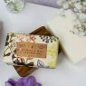 The English Soap Company Jasmine and Wild Strawberry Soap in packaging in a soap dish