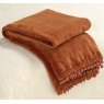 Waltons & Co Cashmere Touch Fleece Spice Throw lifestyle image of the throw draped