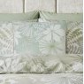 Graham & Brown Bohemia Sage Feather Cushion lifestyle image of the cushion on a white background