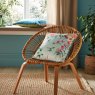 Graham & Brown Ethereal Floral Dawn Feather Cushion lifestyle image of the cushion on a chair