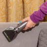 Daewoo Hurricane 1.4L Carpet Spot Washer lifestyle image of the spot cleaner hose in use