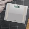 Salter Compact Glass Silver Analyser Bathroom Scale lifestyle image of the scales on the bathroom floor