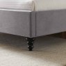 Beatrice Bedstead In Light Grey close up lifestyle image of the front foot of the bedstead