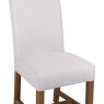 Scroll Back Dining Chair In Natural close up image of the chair on a white background