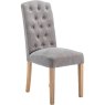 Button Back Dining Chair In Grey side on image of the chair on a white background