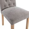 Button Back Dining Chair In Grey close up image of the chair on a white background