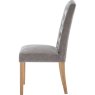 Button Back Dining Chair In Grey side on image of the chair on a white background