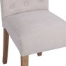 Button Back Dining Chair In Natural close up image of the chair on a white background