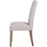 Button Back Dining Chair In Natural side on image of the chair on a white background