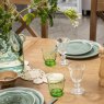 Manor Oak 2m Extending Crossed Leg Dining Table With 4 Cross Back Chairs & Bench close up lifestyle image