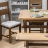 Manor Oak 1.3m Extending Crossed Leg Dining Table With 6 Ladder Back Chairs close up lifestyle image